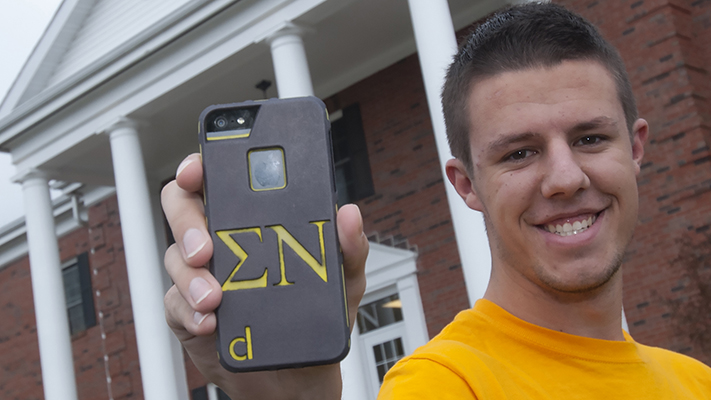 Sophomore Connor Wolk with his engraved iPhone case that sports his fraternity letters. Photo by B.A. Rupert.