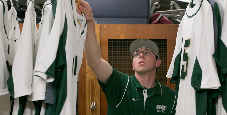 Patrick Murphy prepares the Missouri S&T baseball team’s uniforms before a game against Drury University.