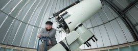 Ken Goss, a senior in computer science and computer engineering, poses with the S&T Observatory's 16-inch diameter telescope. Sam O'Keefe/Missouri S&T